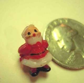   two miniature plastic santa figurines they could have gone with some