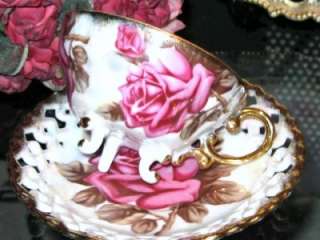 decorated with a single pink rose and bud on the inner cup