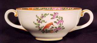 this set has a pattern of a parrot sitting in a wreath of flowers with 