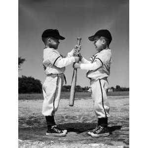  Boys in Little League Uniforms, Facing Each Other, Holding Baseball 