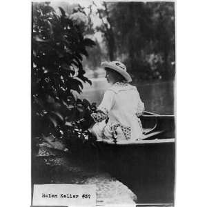 Helen Keller in a boat by shore, c1913