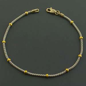   popcorn charm bracelet 14K white and yellow gold. Length is 7 inches